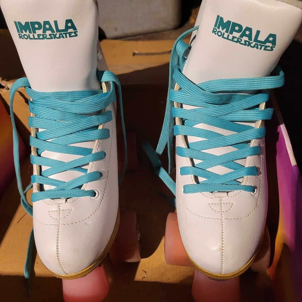 Impala White Roller Skates with Turquoise Laces and Pink Wheels And Bumper.